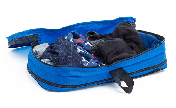 Five pairs of underwear in an open Island (blue) Aether Small Aeronaut 45 Packing Cube all-fabric side up.